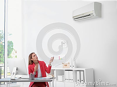 Young woman suffering from heat under broken Stock Photo