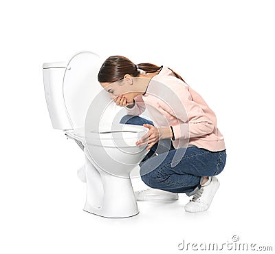 Young woman suffering from nausea near toilet bowl Stock Photo