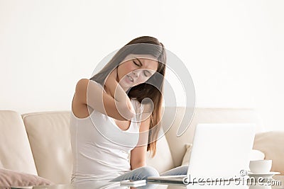 Young woman suffering from pain in tense neck Stock Photo