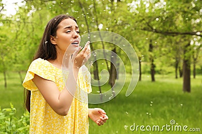 Young woman suffering from seasonal allergy outdoors Stock Photo