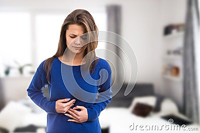 Young woman suffering stomach ache Stock Photo