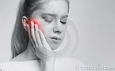 Young woman suffering from tooth pain, caries Stock Photo
