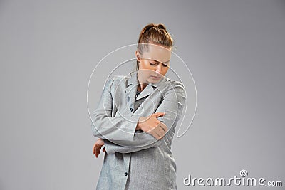 Young woman suffers from pain, feels sick, ill and weakness isolted on studio background Stock Photo