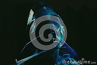 Taking her last breath. A young woman suffocating with her head wrapped in plastic while isolated on a black background. Stock Photo