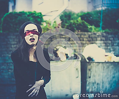 Young woman suffocating herself in garbage environment Stock Photo