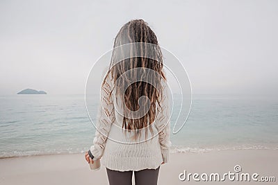 Attractive young woman in sweater watch the horizon line Stock Photo