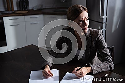 Young woman at table with divorce documents Stock Photo