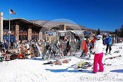 A young woman takes off her skis for a break Editorial Stock Photo