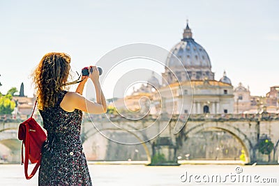 Young woman takes a picture of Cathedral of St. Peter in Rome Stock Photo