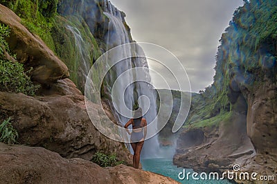 young woman taking picture,Amazing crystalline blue water of Tamul waterfall at Huasteca Potosina in San Luis Potosi, Mexico Editorial Stock Photo