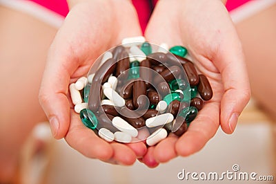 Young woman taking pills Stock Photo