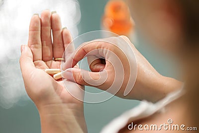 Young woman taking vitamins ginseng pill Stock Photo