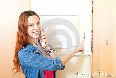 Young woman talking on the house videophone indoor Stock Photo