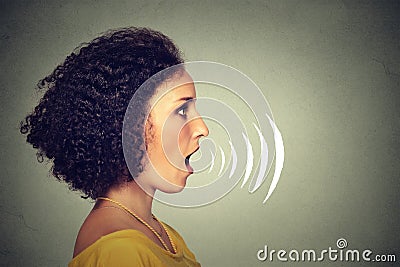 Young woman talking with sound waves coming out of her mouth Stock Photo