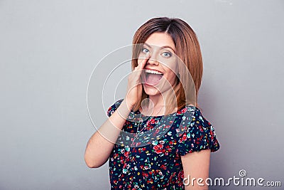 Young woman telling gossip Stock Photo