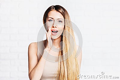 Young woman telling a secret Stock Photo