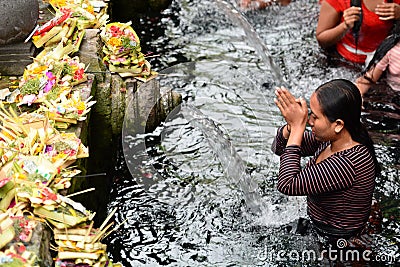 Young woman in the temple pond. Tirta Empul. Tampaksiring. Gianyar regency. Bali. Indonesia Editorial Stock Photo