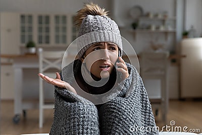 Young woman tenant call apartment management company complain on cold Stock Photo