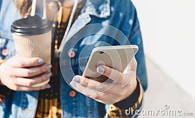 Young woman texting walking down city street Stock Photo