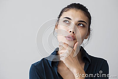 Young woman thinking on gray background Stock Photo