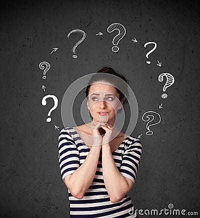 Young woman thinking with question mark circulation around her h Stock Photo