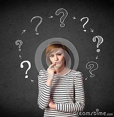 Young woman thinking with question mark circulation around her h Stock Photo