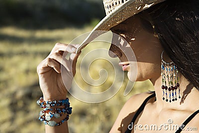 Young woman tipping a cowboy hat. Stock Photo