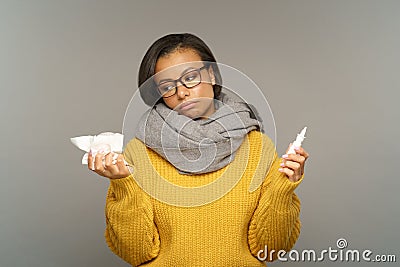 Sick woman tired of sinusitis look on nasal drops and tissues. Ill female suffer from runny rose Stock Photo