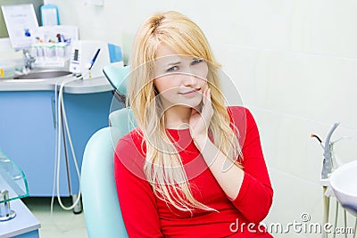 Young woman with toothache in dentist office Stock Photo