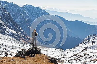 Young woman tourist backpacker standing rock mountain edge. Stock Photo