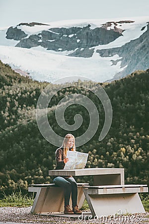 Young Woman tourist with map planning route trip in Norway sitting at the table Travel Lifestyle concept adventure vacations outdo Stock Photo