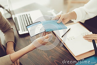 Young Woman in Travel Agency Buying Tickets . Stock Photo