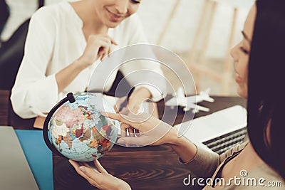 Young Woman in Travel Agency with Smiling Manager. Stock Photo