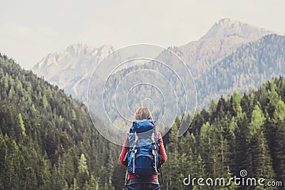 Young woman traveler in Alps mountains. Travel and active lifestyle concept Stock Photo