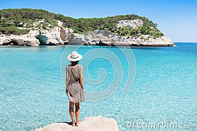 Young woman traveler looking at the sea, travel and active lifestyle concept. Relaxation and vacations concept. Stock Photo