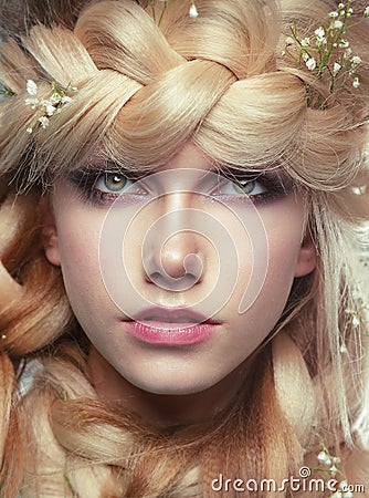 Young Woman with Tress and Flowers Stock Photo