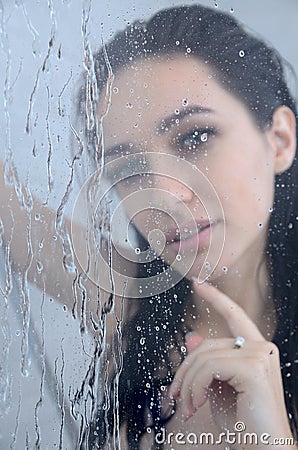 Young woman under shower with water drops Stock Photo