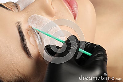 Young woman undergoing eyelash lamination. Professional service Stock Photo