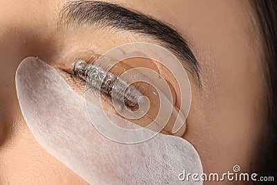 Young woman undergoing eyelash lamination. Professional service Stock Photo