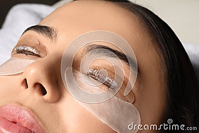 Young woman undergoing eyelash lamination. Professional service Stock Photo