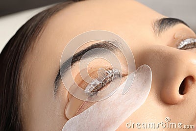 Young woman undergoing eyelash lamination. Professional service Stock Photo