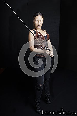 Young woman in urban fantasy poses on a black background Stock Photo