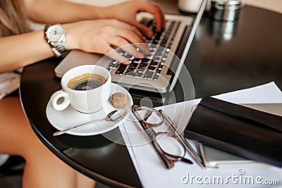 Young woman uses laptop in cafe Stock Photo