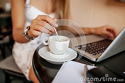 Young woman uses laptop in cafe Stock Photo