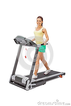 Young woman uses treadmill. Stock Photo