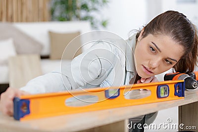 Young woman using spirit level Stock Photo