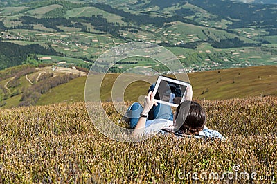 Young woman using tablet computer outdoors Stock Photo