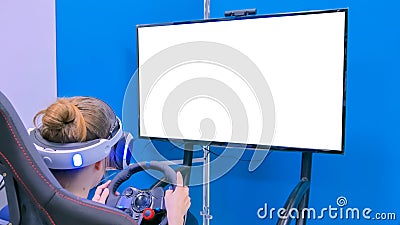 Young woman using virtual reality headset with special wheel joystick Stock Photo