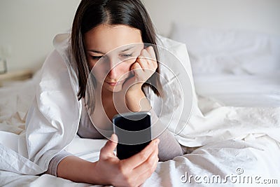 Cyberbullying concept with young sad woman watching smart phone Stock Photo