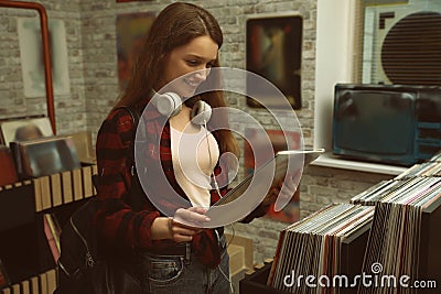 Young woman with vinyl in store Stock Photo